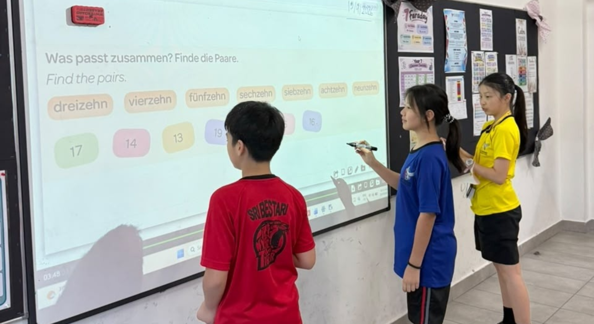 SBIS students taking part in an interactive German lesson at the classroom whiteboard