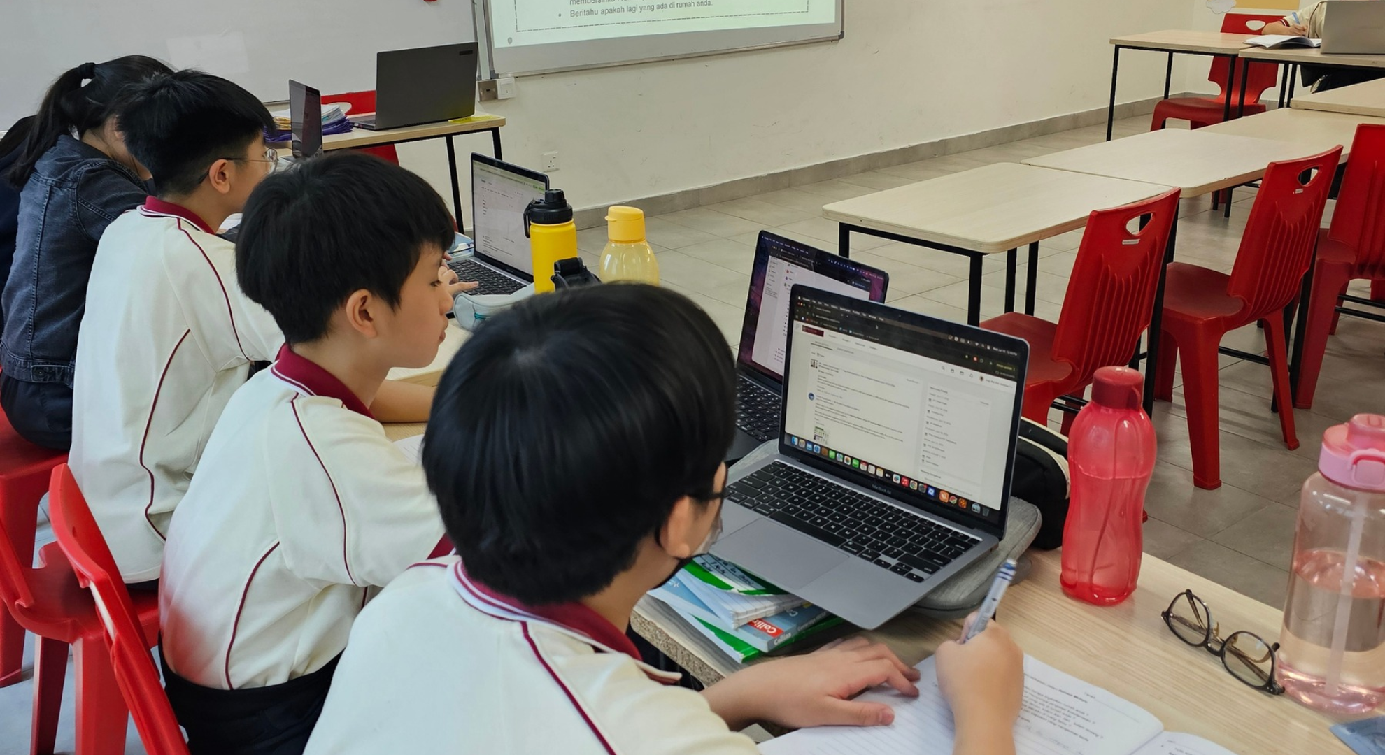 Secondary students using MacBooks during a lesson at Sri Bestari International School
